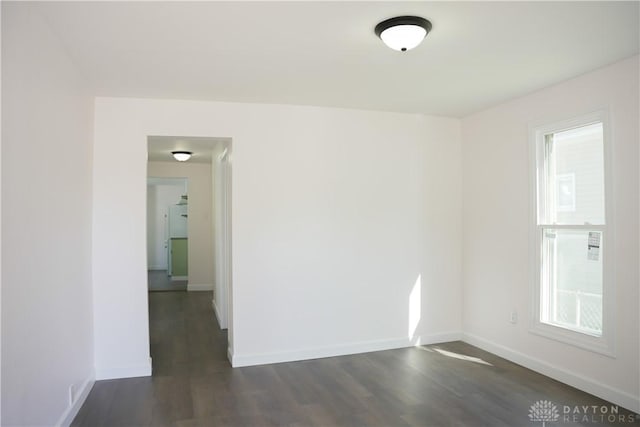 unfurnished room featuring dark wood-type flooring