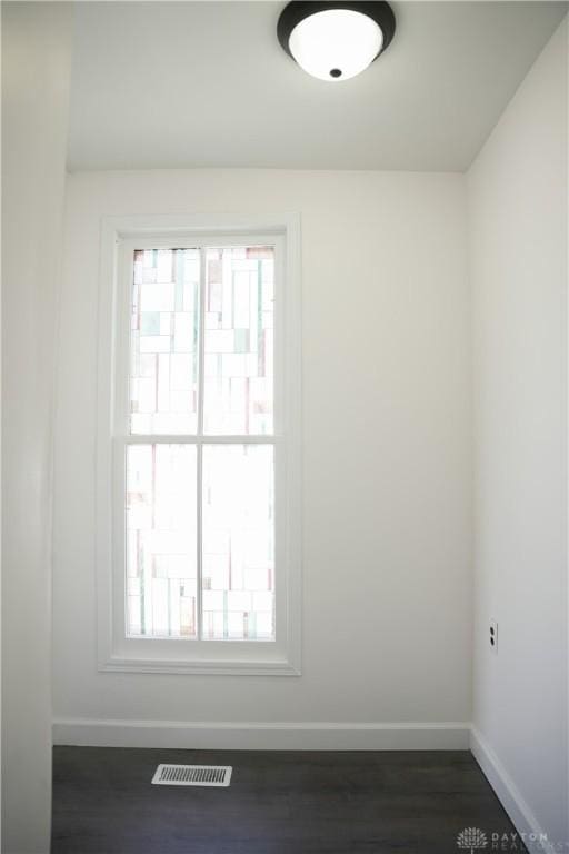 empty room with dark wood-type flooring