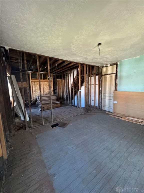 misc room with hardwood / wood-style floors and a textured ceiling