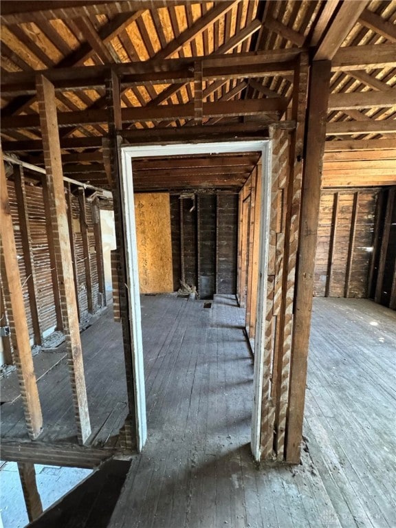 misc room featuring lofted ceiling and hardwood / wood-style floors