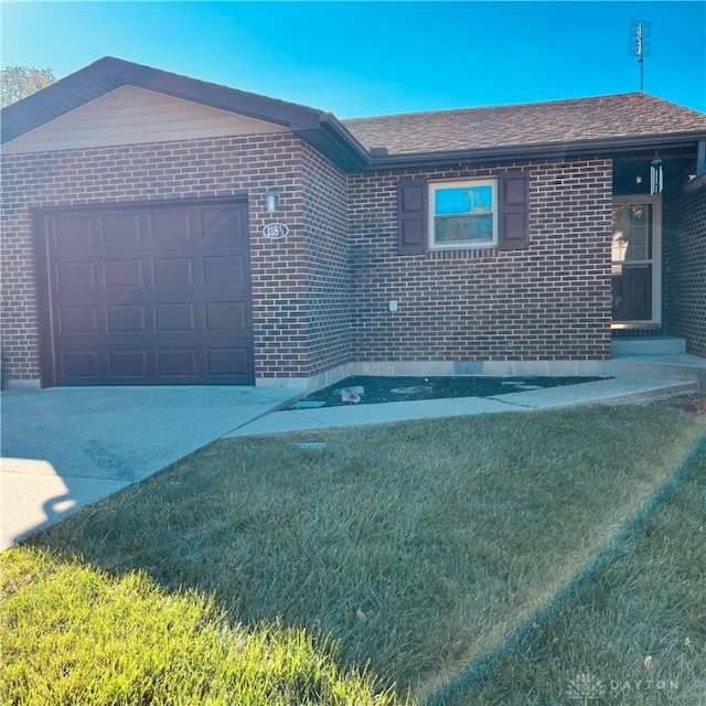 view of front of home with a garage and a front lawn