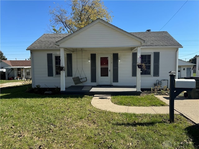 bungalow featuring a porch and a front lawn