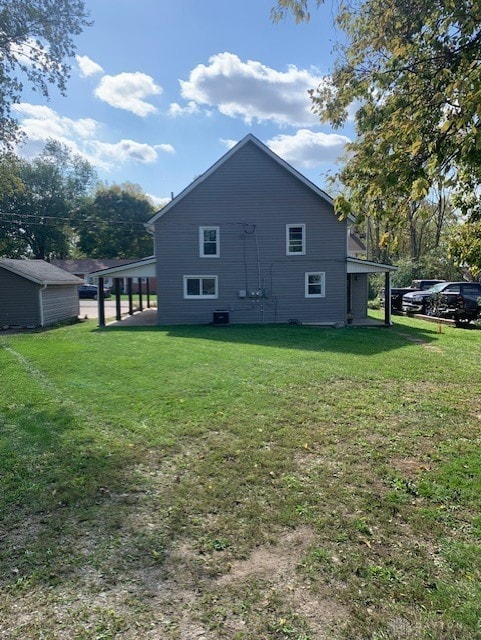 back of property with a lawn