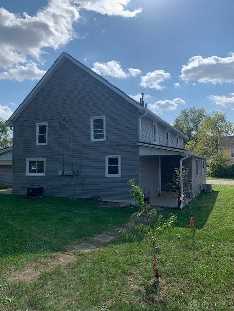 back of property featuring a lawn