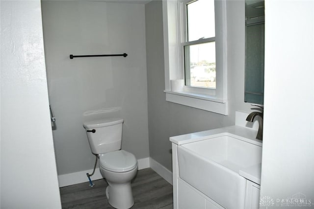 bathroom with hardwood / wood-style floors, vanity, and toilet