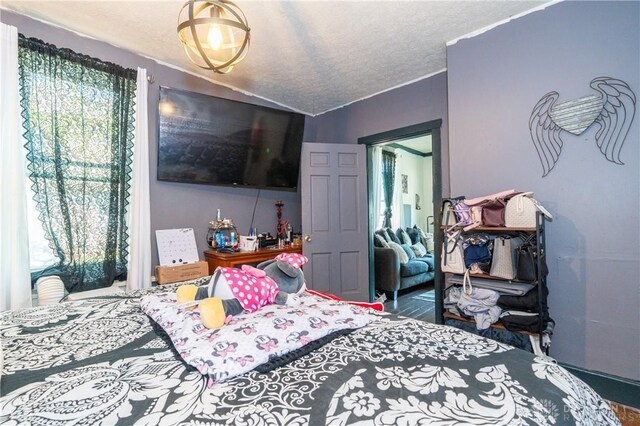 bedroom with a textured ceiling and vaulted ceiling