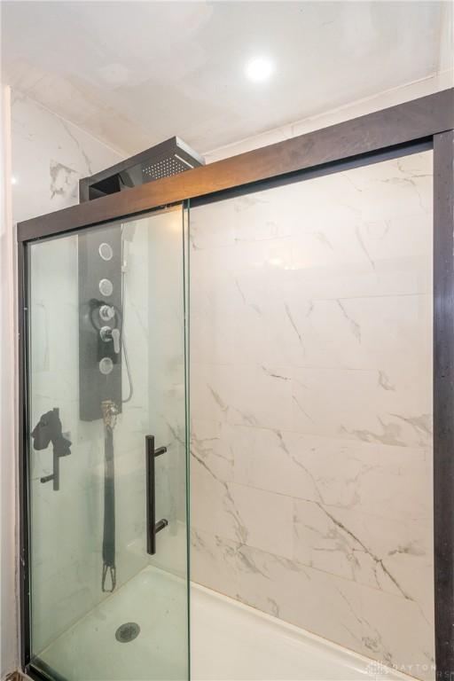 bathroom with a shower with shower door