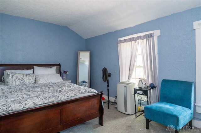 bedroom with light carpet and vaulted ceiling