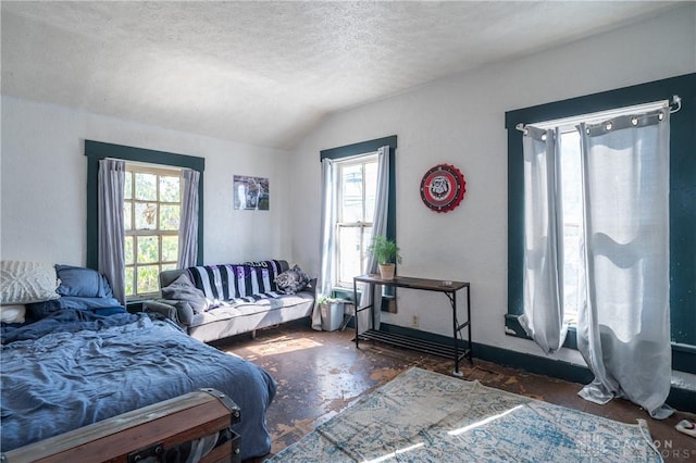 bedroom with vaulted ceiling and a textured ceiling