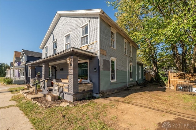 view of front of property with fence and a porch