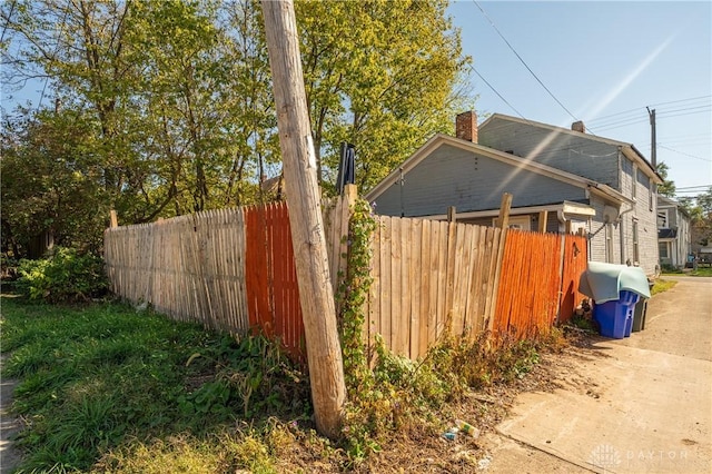 view of side of property featuring fence