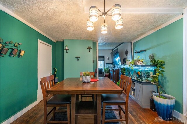 dining room with a textured ceiling and dark wood-type flooring