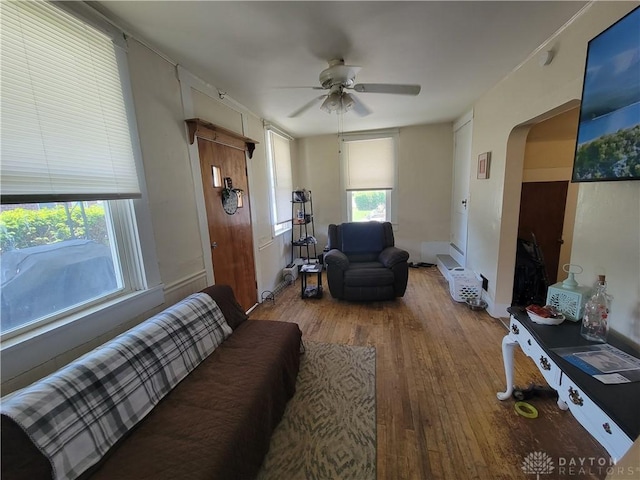 living room with hardwood / wood-style flooring and ceiling fan