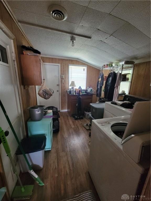 laundry room featuring washer / dryer, hardwood / wood-style floors, and wood walls