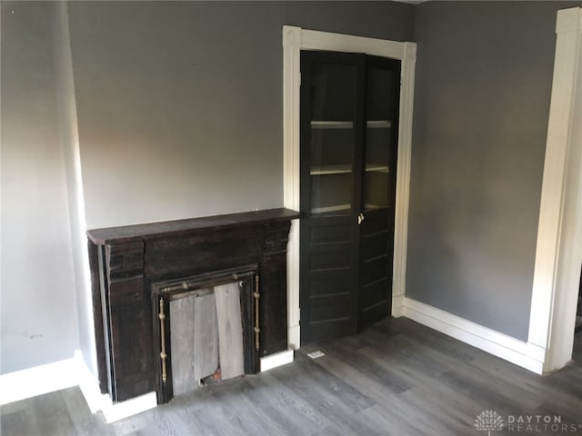 unfurnished living room featuring dark wood-type flooring