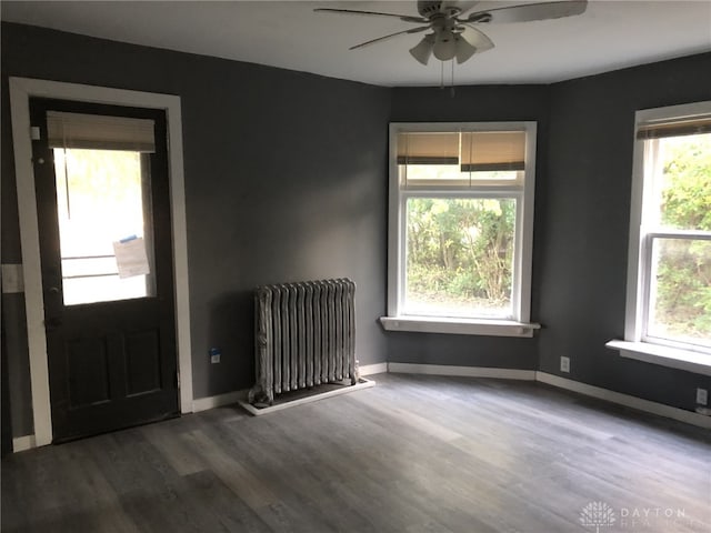 entryway featuring radiator, ceiling fan, baseboards, and wood finished floors