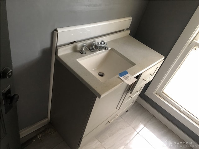 bathroom with vanity and baseboards