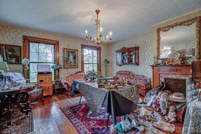 interior space featuring a textured ceiling, multiple windows, and hardwood / wood-style floors