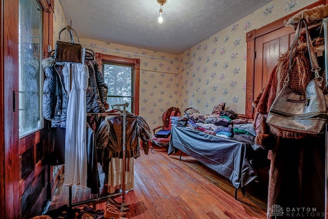 bedroom with hardwood / wood-style flooring and a textured ceiling