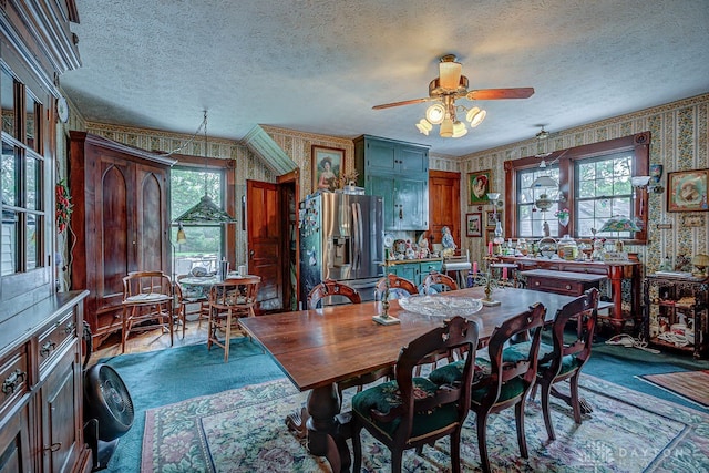 dining space featuring ceiling fan, a healthy amount of sunlight, a textured ceiling, and crown molding