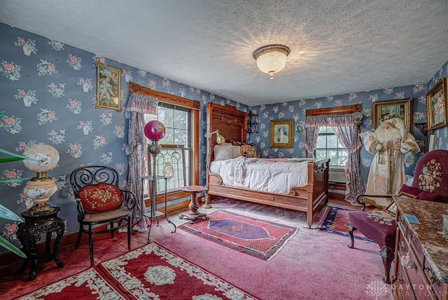 carpeted bedroom with a textured ceiling and multiple windows