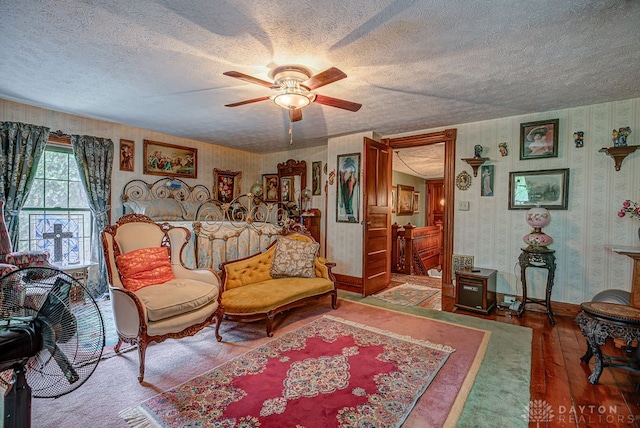 interior space with ceiling fan, hardwood / wood-style flooring, and a textured ceiling