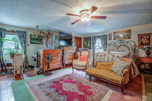 bedroom featuring a textured ceiling, hardwood / wood-style flooring, and ceiling fan