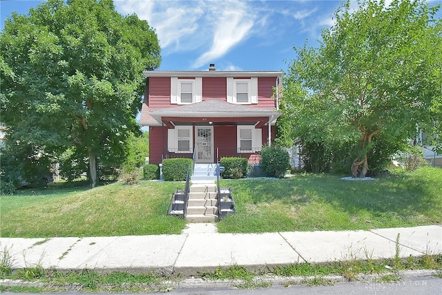 view of front of property with a front yard and a porch