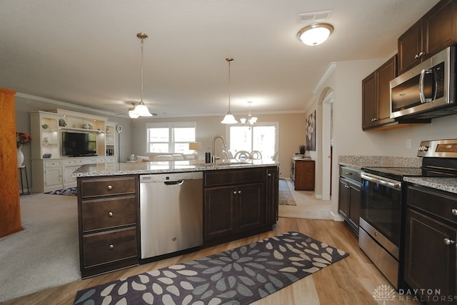 kitchen with crown molding, sink, appliances with stainless steel finishes, decorative light fixtures, and light hardwood / wood-style floors