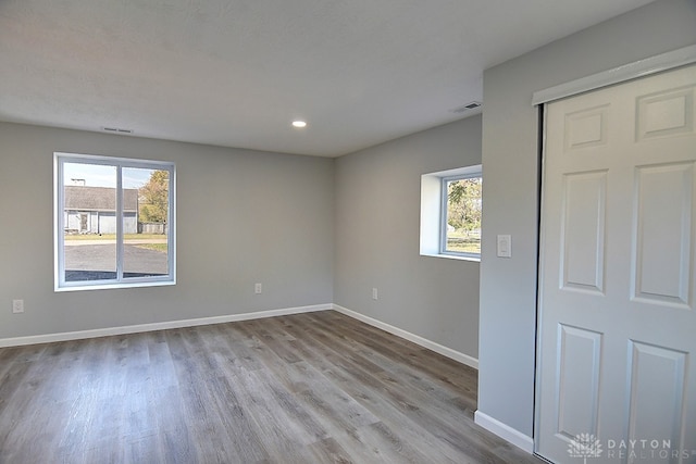 unfurnished room with light hardwood / wood-style flooring and a wealth of natural light