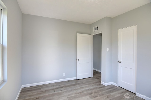 unfurnished bedroom with light hardwood / wood-style flooring