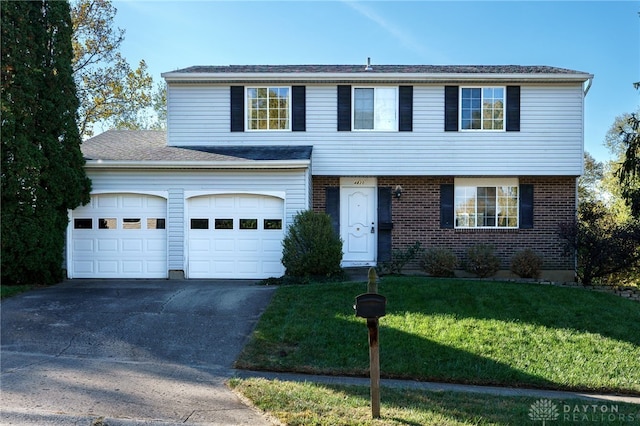 view of front of property with a front yard and a garage