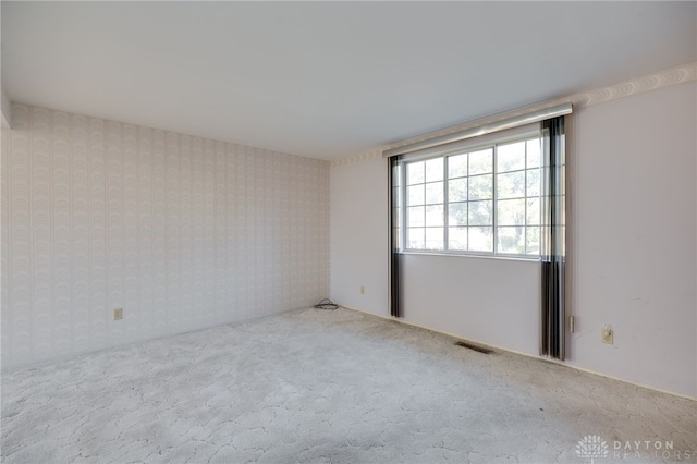 unfurnished room with light carpet