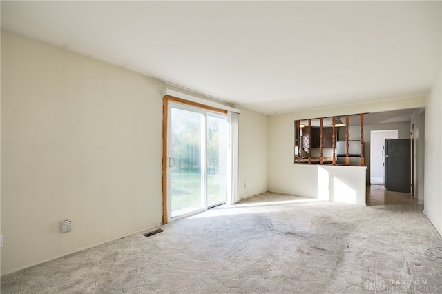 unfurnished living room featuring carpet