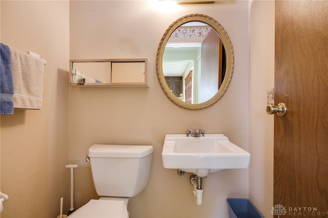 bathroom featuring toilet and sink