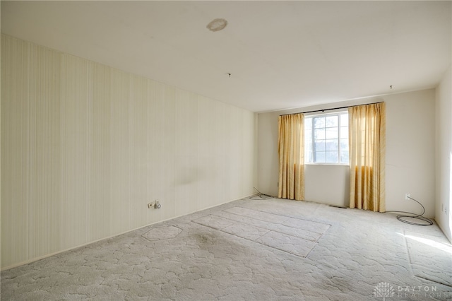 unfurnished room featuring light colored carpet