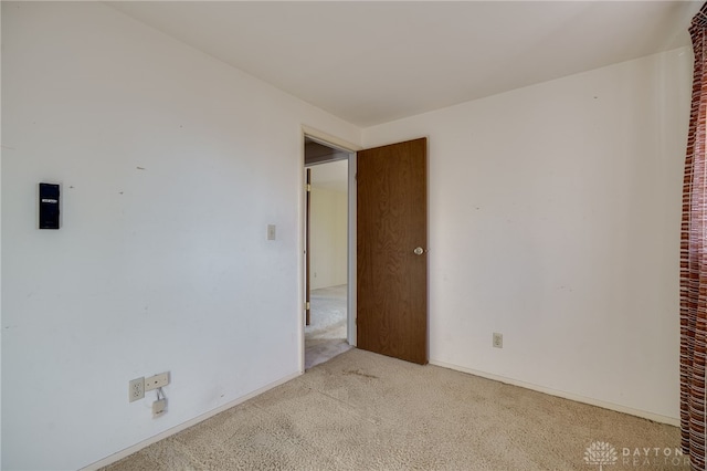 unfurnished room with light colored carpet