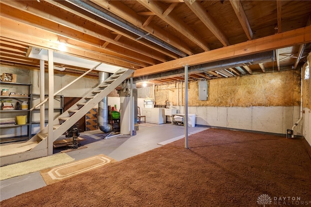 basement featuring washer and dryer and electric panel