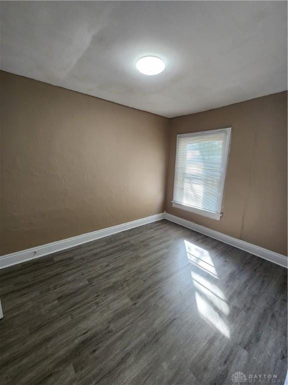 unfurnished room featuring dark hardwood / wood-style floors