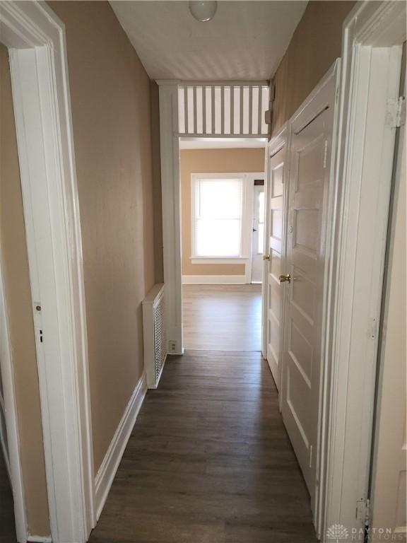 corridor featuring dark hardwood / wood-style floors