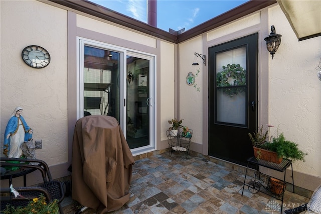 property entrance with a patio area