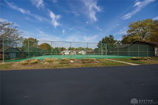 view of property's community featuring tennis court