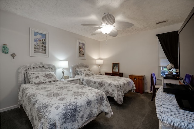 carpeted bedroom with a textured ceiling and ceiling fan