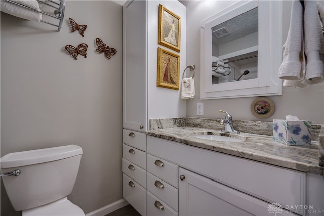 bathroom featuring vanity and toilet