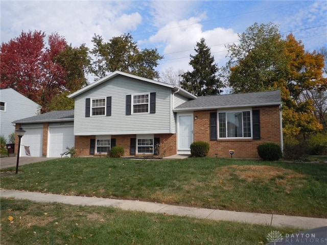 tri-level home featuring a garage and a front lawn