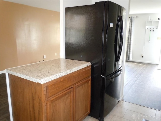 kitchen featuring black refrigerator and light wood-type flooring