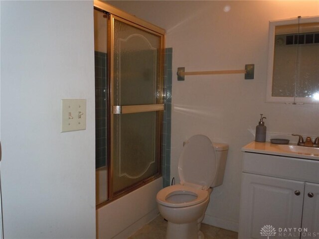 full bathroom featuring vanity, toilet, and shower / bath combination with glass door