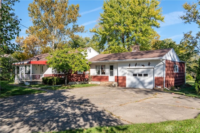 single story home featuring a porch and a garage