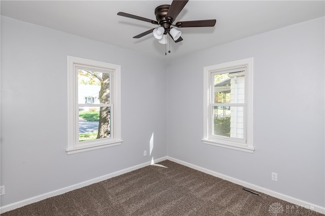 carpeted empty room featuring ceiling fan