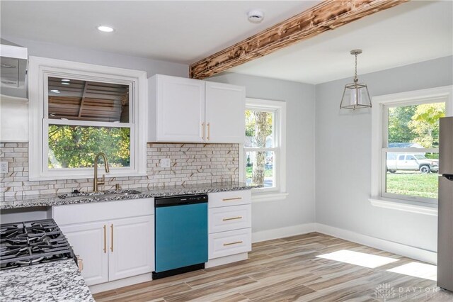 kitchen with beamed ceiling, light hardwood / wood-style flooring, stainless steel appliances, pendant lighting, and light stone counters